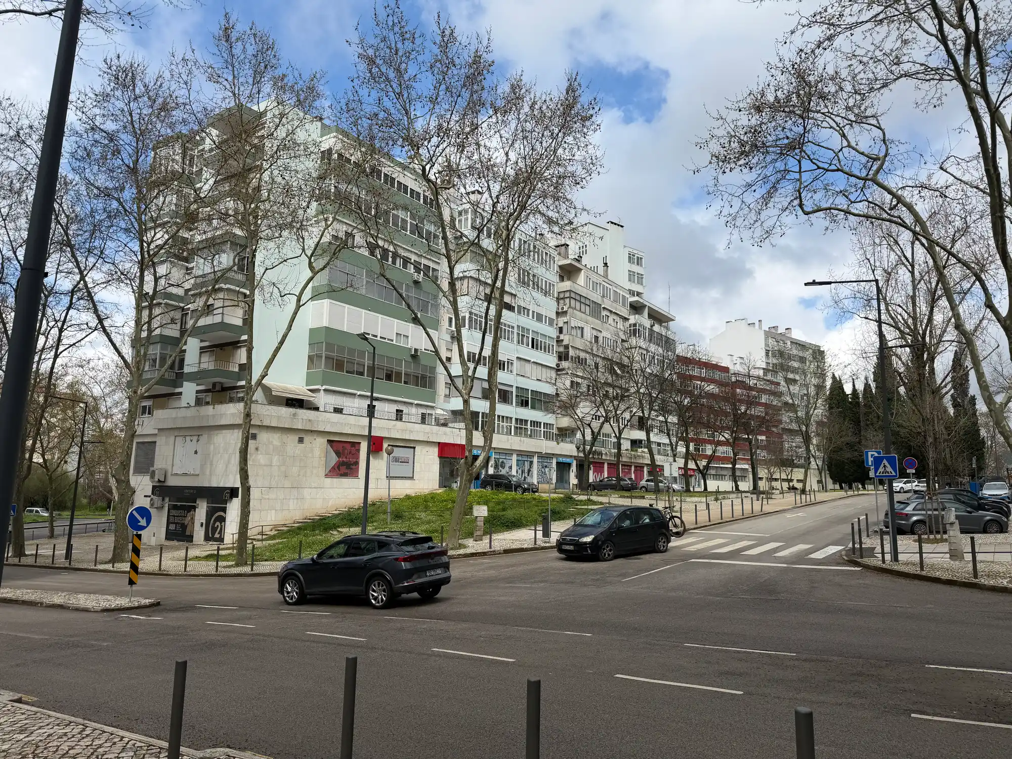 São Domingos de Benfica Lisbon residential street with apartment buildings, trees, and urban traffic