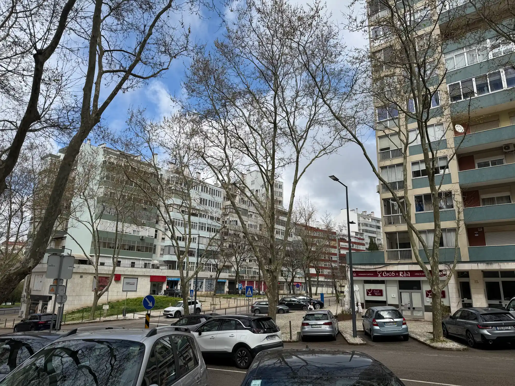 São Domingos de Benfica Lisbon residential area with apartment buildings, parked cars, trees, and local shops